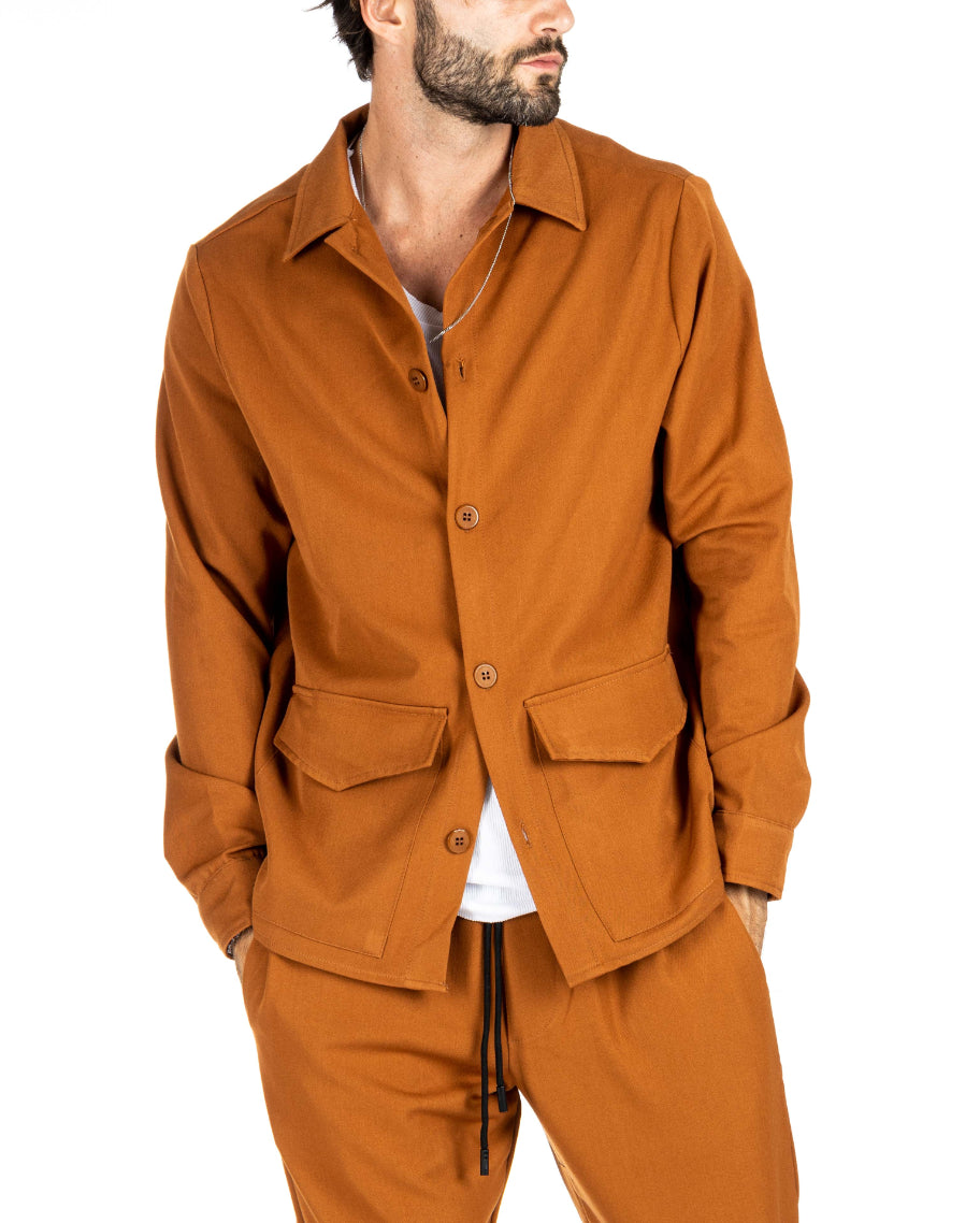 Men's caramel brown overshirt jacket with collar and chest pockets, layered over a white t-shirt, shown on a model