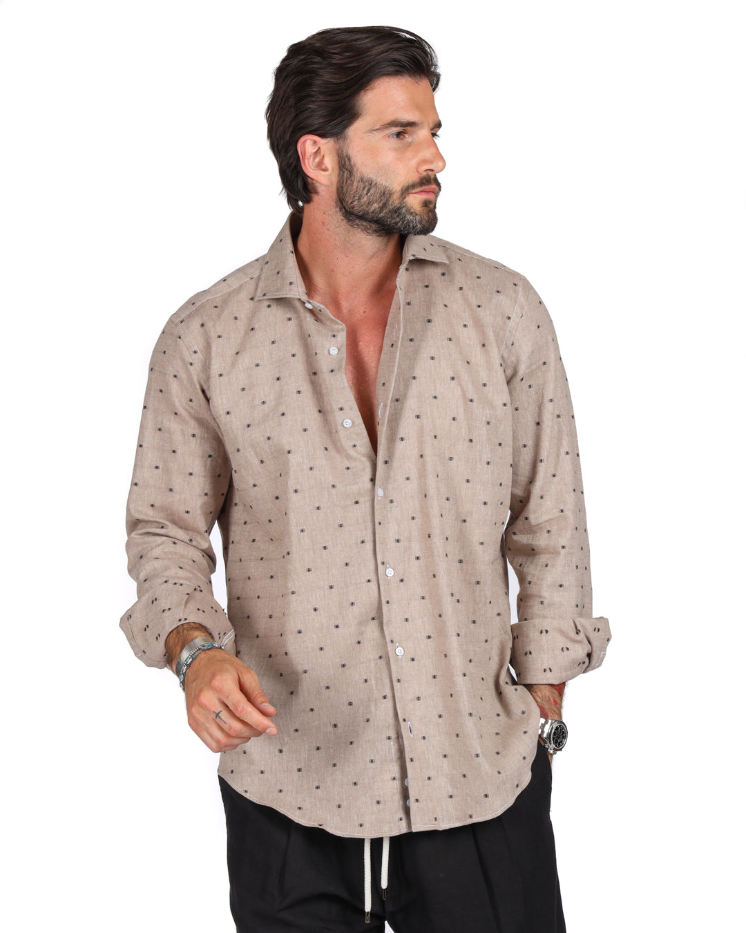 Men's beige linen shirt with brown dot pattern, shown on a model with sleeves rolled