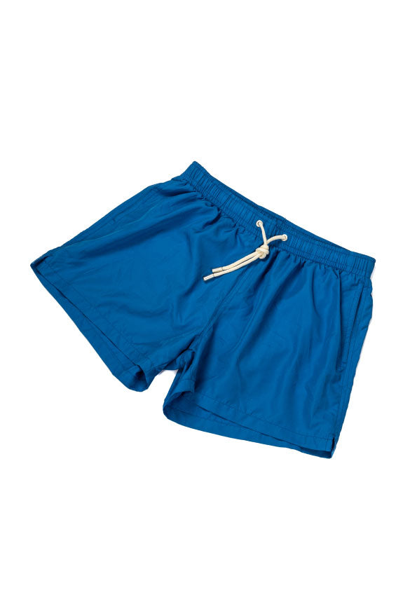 Blue swim shorts with elastic drawstring waistband and side pockets, laid flat